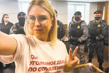  ?? Lyubov Sobol ?? Russian opposition activist Lyubov Sobol — wearing a Tshirt that says “where is the criminal case for the poisoning of Navalny?” — takes a selfie in front of federal officers in a Moscow courtroom.