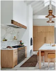  ??  ?? ABOVE: Reclaimed French limestone floors, custom white oak cabinets, Calacatta marble and Gris Catalan limestone counters give a farmhouse kitchen a “been here forever” vibe.