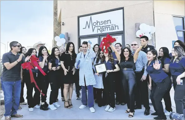  ?? MIA RAMOS PHOTO ?? Dr. Mohsen El Ramah (center, holding scissors) cuts the ribbon a the grand opening of Valley Health Urgent Care, located at 1550 N. Imperial Ave., Suite 1, on Monday, Oct. 17, in El Centro.