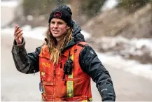  ?? ?? Ryan Guhne, a seasonal employee at Taos Ski Valley, directs traffic Saturday. Guhne lives with his girlfriend, another seasonal employee, at Columbine Inn, a staff housing building located in the village of Taos Ski Valley.