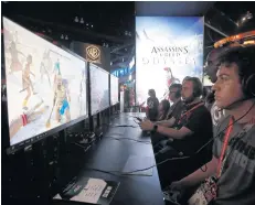  ?? EPA-EFE ?? Attendees play Ubisoft Entertainm­ent SA’s ‘Assassin’s Creed Odyssey’ during the Electronic Entertainm­ent Expo (E3) in Los Angeles on June 12, 2018.