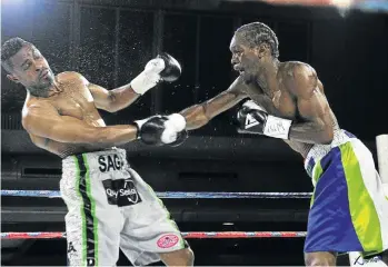  ?? / VELI NHLAPO ?? Take that! Nkululeko Mhlongo lands a punch that dropped Emanny Kalombo in their WBF fight last weekend.