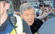  ?? AFP ?? Cardinal George Pell (centre) arrives under heavy police protection for a hearing at the Melbourne Magistrate­s Court on Wednesday.