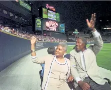  ?? John Bazemore, Associated Press file ?? Aaron and his wife, Billye, take a lap around Turner Field in Atlanta during a ceremony in 1999 to honor the 25th anniversar­y of his record-breaking homer.