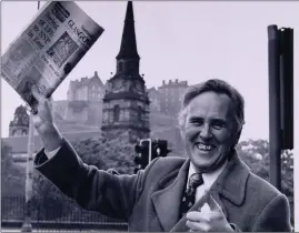  ?? ?? Main image: Wolfe with a replica claymore in 1962. Left, top: Wolfe with a copy of the Glasgow Herald prior to the October 1974 election; bottom: Wolfe on Eilean Mor MacCormick in the Sound of Jura. The island is held in trust for Scots by the SNP