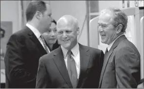  ?? AP/GERALD HERBERT ?? Former President George W. Bush (right) chats with New Orleans Mayor Mitch Landrieu before a conference on education Friday at Warren Easton Charter High School in New Orleans.