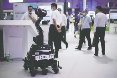  ?? ALY SONG/REUTERS FILES ?? A security robot does its job at a booth during the Huawei Connect trade show in Shanghai, China.
