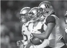  ?? Rich Schultz / Getty Images ?? Washington’s Dante Pettis celebrates after he returned a punt for a touchdown against Rutgers in the second quarter.