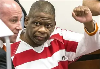  ?? Ricardo Brazziell/Austin American-Statesman via AP ?? Death row inmate Rodney Reed waves to his family on Oct. 13, 2017, in the Bastrop County District Court in Bastrop, Texas. Supporters for Reed, who's facing lethal injection in less than two weeks for a murder he says he didn't commit, are mounting a final push in the courts, on social media and outside the governor’s mansion to stop his execution.