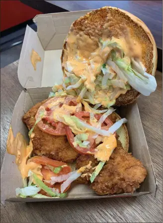  ?? (Arkansas Democrat-Gazette/Eric E. Harrison) ?? McDonald’s Crispy Chicken Sandwich replaces the McChicken. A deluxe version of the sandwich adds shredded lettuce, Roma tomatoes and mayonnaise, or in this case, Spicy Pepper Sauce.