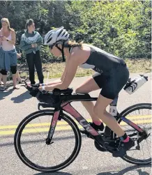  ??  ?? Jane Cunningham on the bike during Ironman 70.3 Maine. The race, which covers half the Ironman distances for swimming, biking and running, was held Aug. 25 in Old Orchard Beach, Maine.