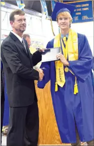  ?? Photo by Mike Eckels ?? Aaron Owens (left) presented his son Bracy with his diploma during the 2017 Decatur High School graduation ceremony May 14 at Peterson Gym in Decatur.