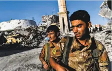  ?? Bulent Kilic / AFP / Getty Images ?? Members of the U.S.-backed Syrian Democratic Forces patrol in Raqqa. The SDF is seeking to oust Islamic State fighters.