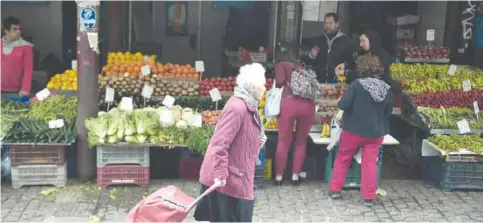  ??  ?? ATHENS: People shop at Athens main green market in city’s center yesterday. Greece in 2016 registered a primary surplus of 3,9 percent of output, the statistics agency said yesterday, in a key announceme­nt for the country’s reform talks with its...