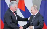  ??  ?? MAXIM SHEMETOV/REUTERS Russian President Vladimir Putin and Cuban President Miguel Diaz-canel shake hands during a joint news conference following their meeting at the Kremlin in Moscow, Russia, on November 2, 2018.