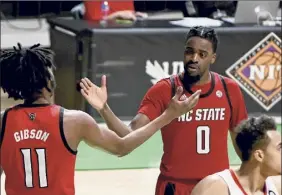  ?? Matt Strasen / Associated Press ?? North Carolina State’s DJ Funderburk, right, celebrates with Jaylon Gibson after Gibson drew a foul late in the second half Thursday.