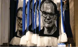  ?? Photograph: Oli Scarff/AFP/Getty ?? ▲ Marcelo Bielsa scarves for sale outside Leeds’ Elland Road stadium. The manager has disciples across the world and uses them to assist him.