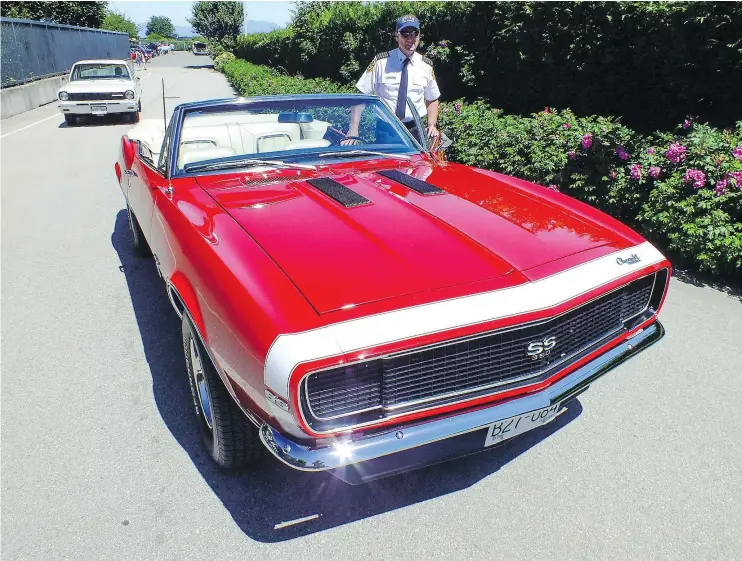  ?? CAM HUTCHINS/PNG ?? Delta Chief of Police Dan Copeland loves to show off his speedy-looking fire truck-red 1967 Chevrolet Camaro four-speed convertibl­e.