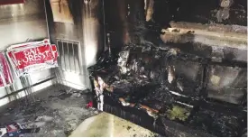  ?? — AP ?? HILLSBOROU­GH: A burned couch is shown next to warped campaign signs at the Orange County Republican Headquarte­rs in Hillsborou­gh, NC.