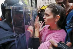  ??  ?? Violence: Police push voters in Barcelona on October 1