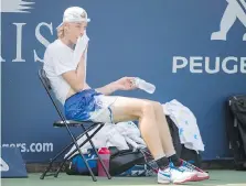  ??  ?? Shapovalov, seen taking a break during a training session Thursday in Montreal, says life has changed since his Rogers Cup breakthrou­gh. “As for social media, I think I went up 30,000 followers,” he says.