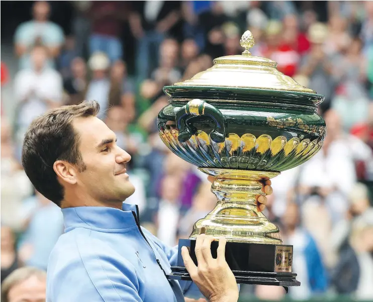  ?? — GETTY IMAGES ?? Roger Federer hoists the trophy after beating Alexander Zverev to win the Gerry Weber Open. It was the 35-year-old Federer’s fourth title of the year.