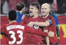  ?? FRANK GUNN THE CANADIAN PRESS ?? Toronto FC defender Nick Hagglund celebrates his goal with teammates Michael Bradley and Steven Beitashour during second half MLS Eastern Conference playoff soccer final action against the Montreal Impact.
