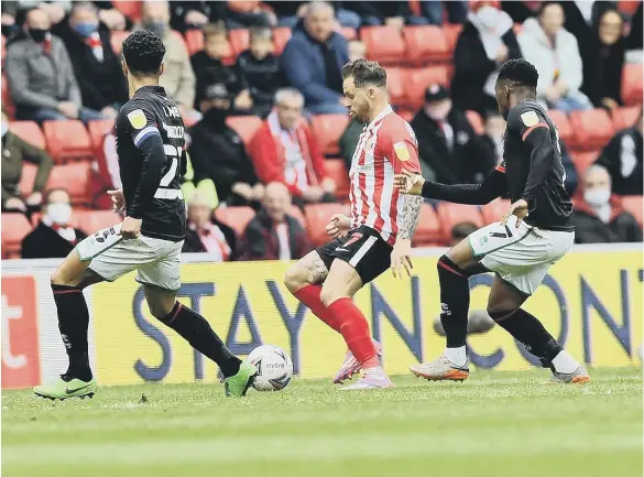  ??  ?? Chris Maguire takes on the Lincoln City defence in Saturday’s second leg. Pictures by Frank Reid and Martin Swinney.