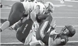  ?? AP ?? Oregon State quarterbac­k Jake Luton (6) is sacked by Arizona State defensive linemen Jermayne Lole and Roe Wilkins.