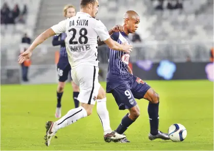  ??  ?? BORDEAUX: Bordeaux’s Uruguayan forward Diego Rolan (R) vies with Caen’s French defender Damien Da Silva during the French L1 football match between Bordeaux and Caen on Sunday at the Matmut Atlantique stadium in Bordeaux, southweste­rn France. — AFP