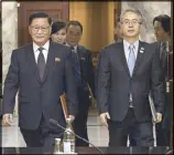  ?? AP ?? South Korea unificatio­n ministry head Lee Woo-sung (right) and his North Korean counterpar­t Kwon Hook-bong arrive in Panmunjom yesterday for their meeting.