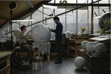  ?? KIN CHEUNG / ASSOCIATED PRESS ?? Artists make a globe at a studio in London, on Feb. 27. Globes in the age of Google Earth capture the imaginatio­n and serve as snapshots of how the owners see the world and their place in it. Peter Bellerby made his first globe for his father, after he could not find one accurate or attractive enough. In 2008, he founded Bellerby & Co. Globemaker­s in London. His team of dozens of artists and cartograph­ers has made thousands of bespoke globes up to 50 inches in diameter. The most ornate can cost six figures.