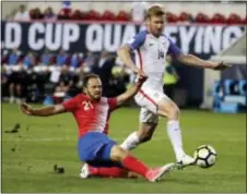  ?? JULIO CORTEZ — THE ASSOCIATED PRESS ?? Costa Rica forward Marco Urena, left, scores as United States’ Tim Ream defends during the first half of a World Cup qualifying match Friday in Harrison.