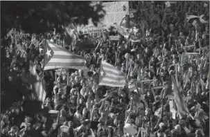  ?? The Associated Press ?? CATALONIA: Thousands of protesters wave Catalonia independen­ce flags as they take part at a rally against the National Court's decision to imprison civil society leaders Saturday in Barcelona, Spain. The Spanish government moved decisively Saturday to...