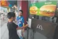  ?? Ng Han Guan, Associated Press file ?? Boys open the door to a McDonald’s restaurant in Beijing.