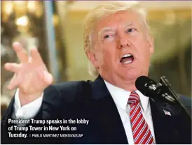  ??  ?? President Trump speaks in the lobby of Trump Tower in New York on Tuesday.
| PABLO MARTINEZ MONSIVAIS/ AP