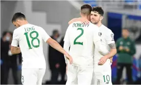  ??  ?? Matt Doherty is consoled by Robbie Brady and Shane Long after his penalty hit the bar to end the Republic of Ireland’s hopes of reaching Euro 2020. Photograph: Radovan Stoklasa/ Reuters