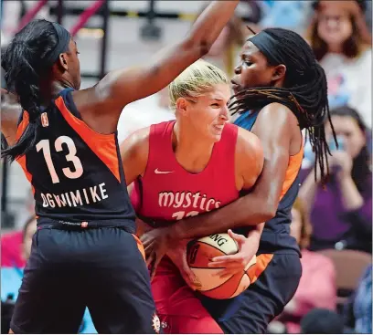  ?? SEAN D. ELLIOT/THE DAY ?? Connecticu­t Sun center Jonquel Jones, right, wraps up Washington Mystics forward Elena Delle Donne as Chiney Ogwumike (13) helps on defense in the second half of Wednesday night’s WNBA game at Mohegan Sun Arena.