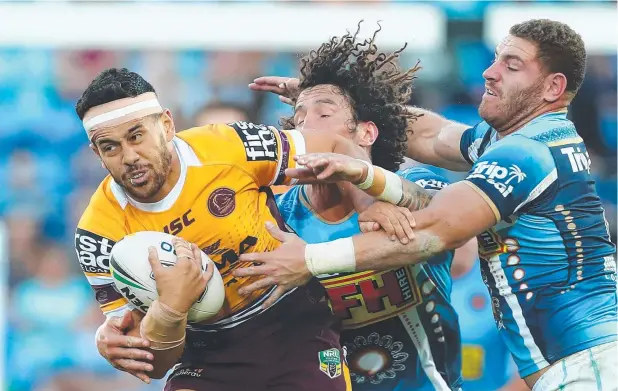  ?? Picture: GETTY ?? A REAL HANDFUL: Jordan Kahu of the Broncos gets tackled during his side’s impressive 34-0 win over the Gold Coast Titans.