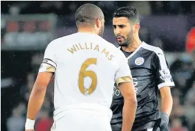  ??  ?? > Ashley Williams squares up with Leicester’s Riyad Mahrez