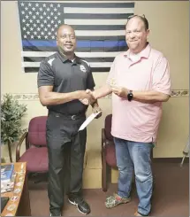  ?? Submitted Photos ?? Forrest City Police Department Officers, from left, Sean Voudren, Russell Hinsley and Billy Spencer, were recently promoted to patrol sergeants with the agency. Above, Voudren, Hinsley and Spencer pose for photos with FCPD Chief Deon Lee.