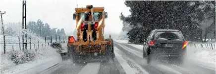  ?? PHOTO: BARRY HARCOURT ?? A grader clears snow on State Highway 94 between Te Anau and Mossburn yesterday morning.