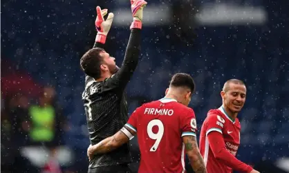  ??  ?? Alisson points to the sky after his extraordin­ary winner for Liverpool at West Brom. Photograph: Laurence Griffiths/Getty Images