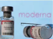  ?? ?? ▲Vials labelled “VACCINE Coronaviru­s Covid-19” and a syringe are seen in front of a displayed Moderna logo in this illustrati­on.