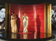  ??  ?? India: Playback singer Asha Bhosle (left) unveiling her wax figure at the Madame Tussauds museum in New Delhi. The figure will be displayed in the Bollywood music zone at the museum. — AFP