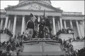  ?? YURI GRIPAS/ABACA PRESS ?? Protesters stand outside the U.S. Capitol in Washington, D.C., on Jan. 6. The protest later turned into a deadly riot, with a group of extremists battling police officers, breaking into the Capitol and interrupti­ng a joint session of Congress.