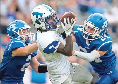  ?? / Steven Eckhoff ?? Trion’s Chris Pace (center) pulls in a reception while being flanked by Armuchee’s Adam Hart (left) and Brayden Presley during Friday’s game at Armuchee. Trion went on to win 48-13.