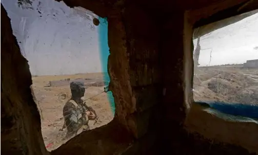  ?? AFP ?? AN IRAQI soldier patrols a checkpoint in the northern city of Tuz Khurmatu, close to locations of jihadist Islamic State of Iraq and the Levant fighters.