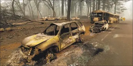  ?? Carolyn Cole Los Angeles Times ?? THE TOWN of Paradise, strewn with charred vehicles, was rendered silent after the destructiv­e Camp fire tore through Butte County.