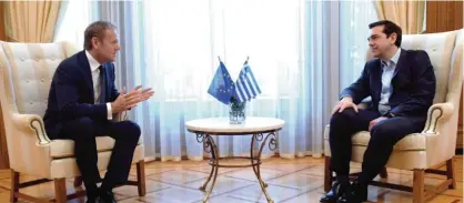  ?? — AFP ?? ATHENS: European Council’s President Donald Tusk (left), gestures as he speaks with Greek Prime Minister Alexis Tsipras (right), during their meeting in Athens yesterday.